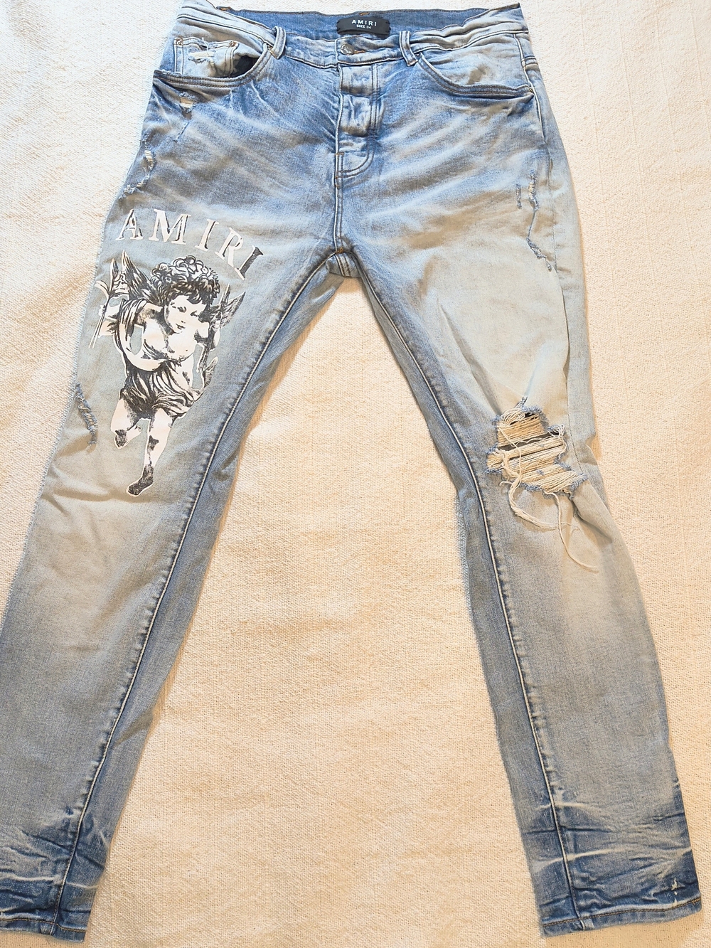 AMIRI Light Blue Distressed Jeans with Cherub Graphic